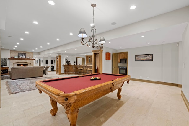 playroom featuring baseboards, billiards, a large fireplace, and recessed lighting