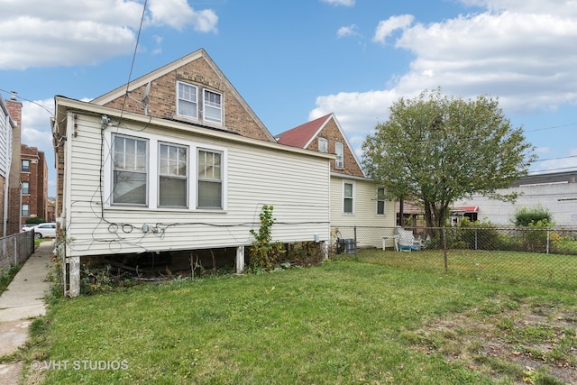 back of property featuring a lawn