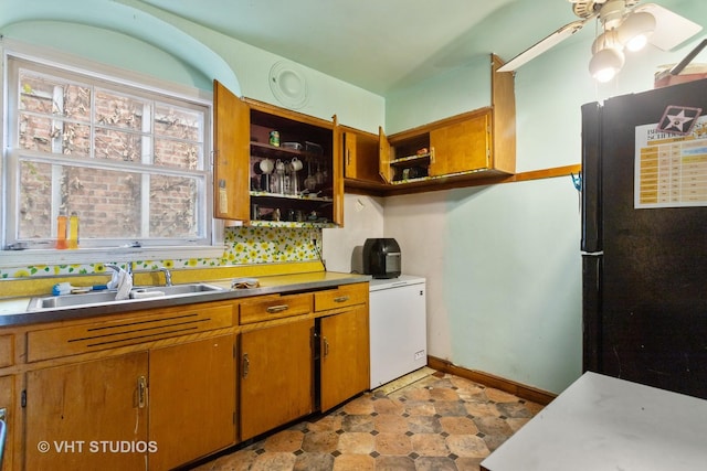 10238 S Vernon Ave, Chicago, IL 60628 - kitchen featuring a sink, open shelves, freestanding refrigerator, and brown cabinetry