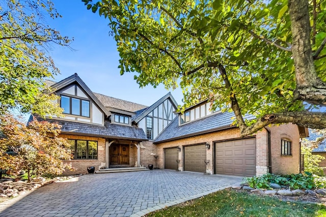 english style home featuring a garage