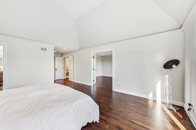 bedroom with high vaulted ceiling, dark hardwood / wood-style floors, and ensuite bath