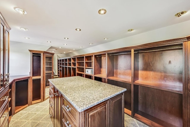 spacious closet featuring light colored carpet