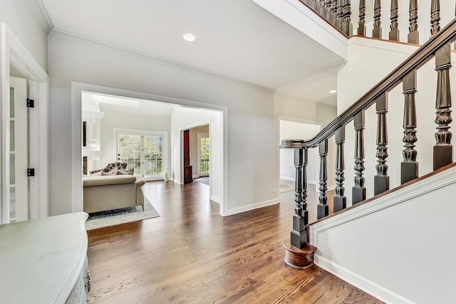 entrance foyer with hardwood / wood-style floors and ornamental molding