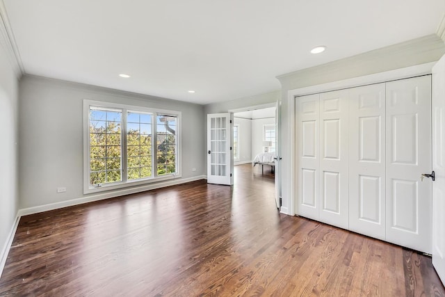 unfurnished bedroom with french doors, dark hardwood / wood-style floors, and ornamental molding