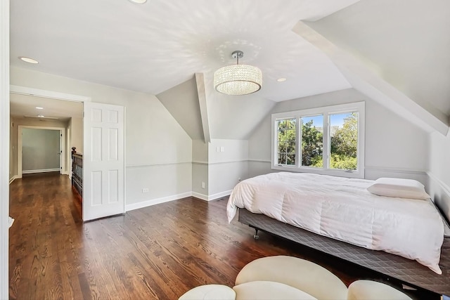 bedroom featuring dark hardwood / wood-style flooring and lofted ceiling