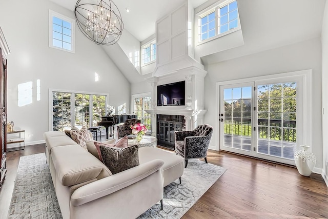 living room with hardwood / wood-style flooring, plenty of natural light, and high vaulted ceiling