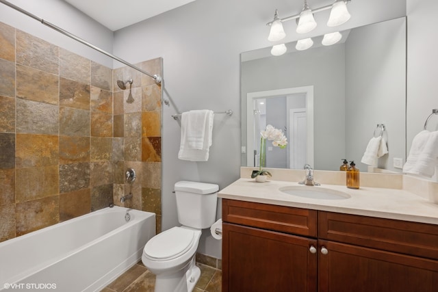 full bathroom with toilet, tiled shower / bath combo, vanity, and tile patterned floors