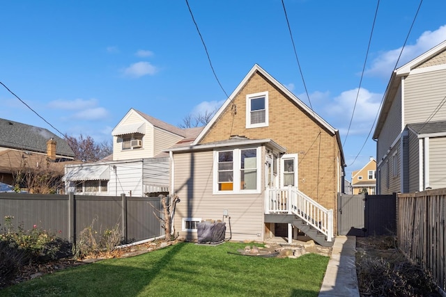 rear view of property with a yard