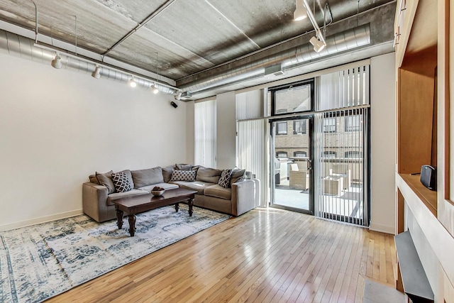 living room with hardwood / wood-style flooring and track lighting