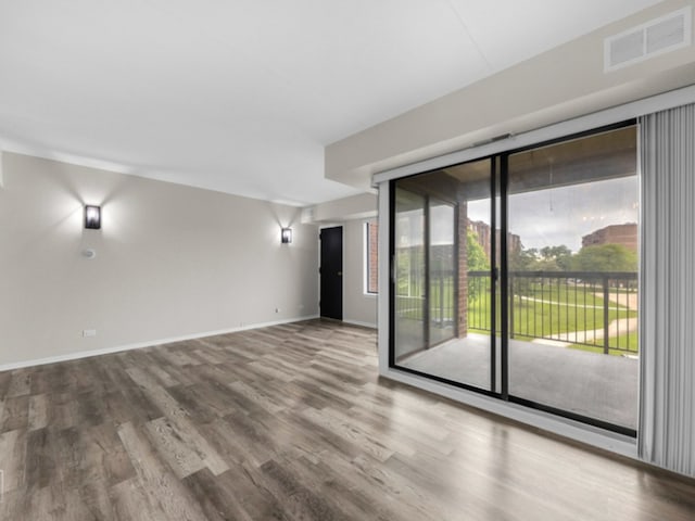 empty room with hardwood / wood-style floors