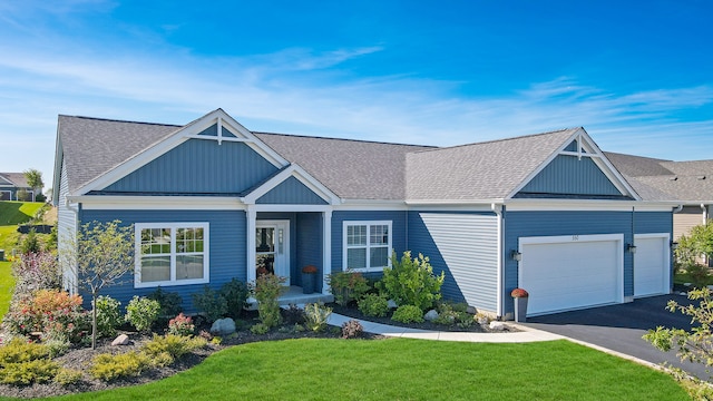 view of front facade with a garage and a front lawn