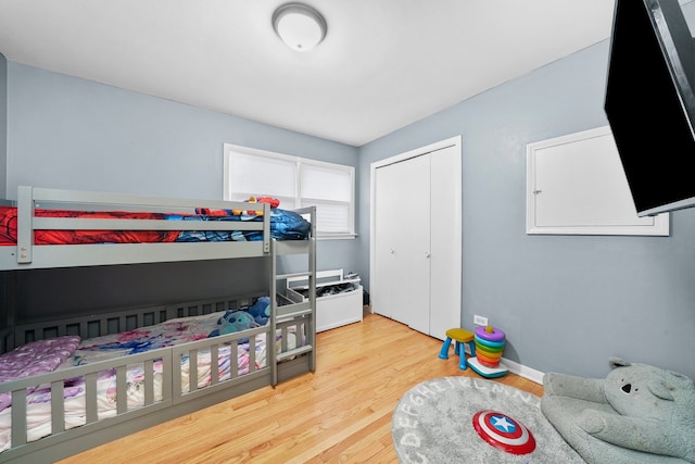 bedroom with hardwood / wood-style floors and a closet