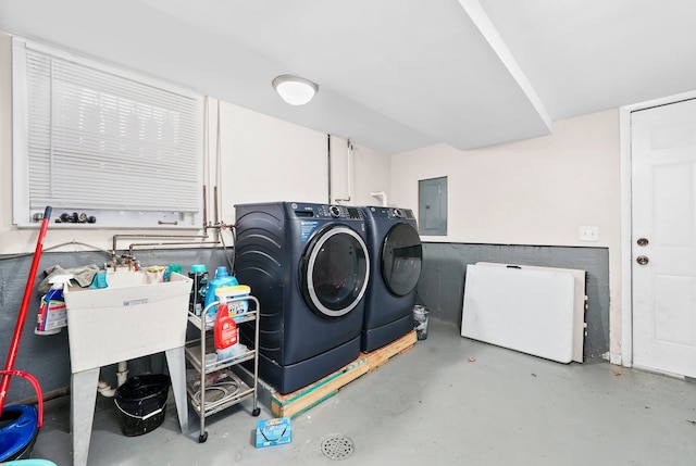 clothes washing area featuring electric panel and washing machine and clothes dryer