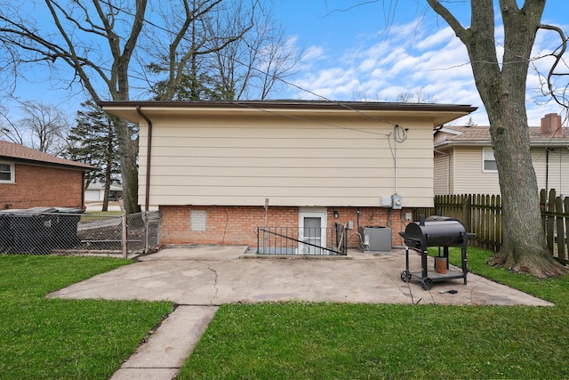 back of property featuring a yard, a patio, and central AC unit