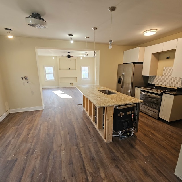 kitchen featuring dark wood-type flooring, white cabinets, pendant lighting, and stainless steel appliances