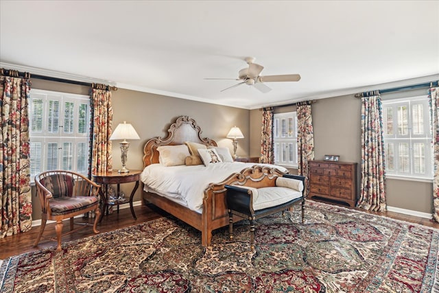 bedroom featuring dark hardwood / wood-style flooring, crown molding, and ceiling fan