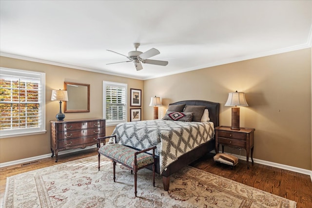 bedroom with ornamental molding, hardwood / wood-style floors, and ceiling fan