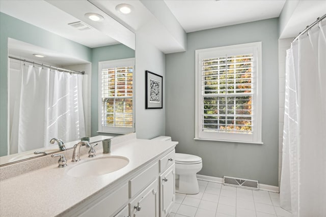 bathroom featuring vanity, toilet, and tile patterned floors