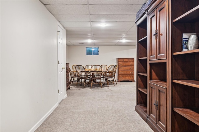 carpeted dining room with a drop ceiling