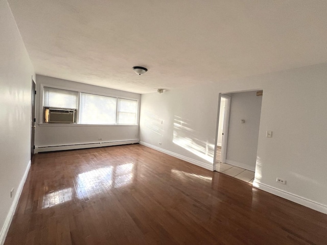 unfurnished room featuring hardwood / wood-style flooring, cooling unit, and a baseboard heating unit