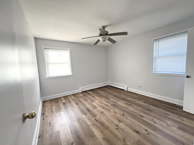 unfurnished room with ceiling fan, a baseboard radiator, and hardwood / wood-style flooring