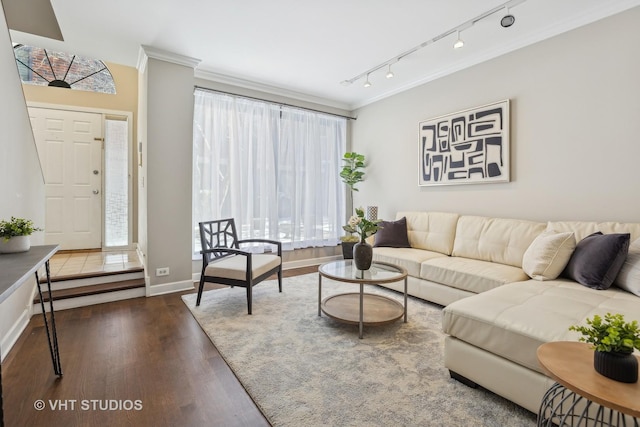 living room with crown molding, track lighting, and dark hardwood / wood-style floors