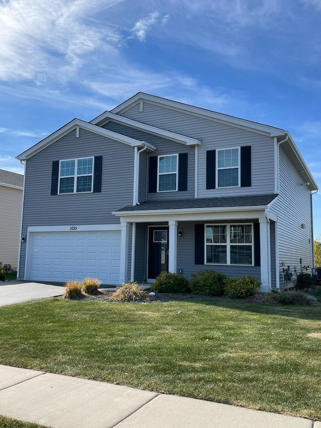 front facade featuring a front yard and a garage