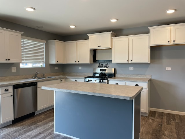 kitchen featuring sink, white cabinetry, dark wood-type flooring, and stainless steel appliances