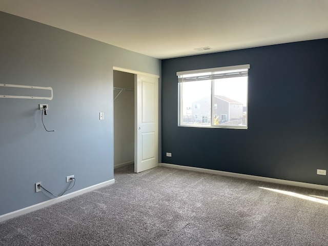 unfurnished bedroom with a closet and carpet floors