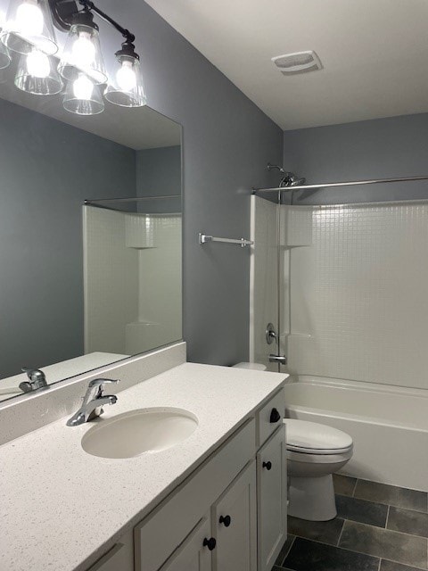 full bathroom featuring toilet, vanity, tile patterned floors, and tub / shower combination