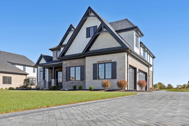 view of front of property with a front yard and a garage