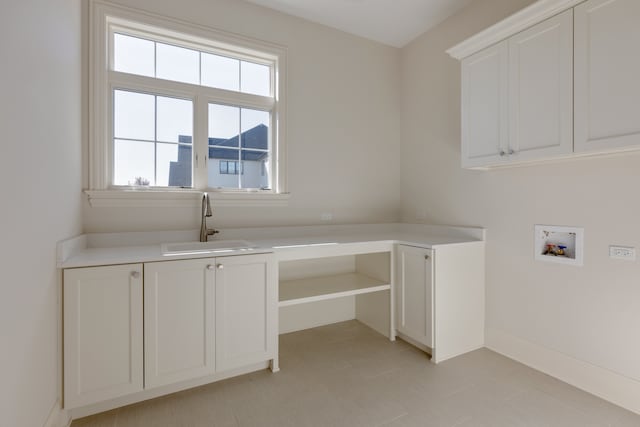 clothes washing area featuring cabinets, hookup for a washing machine, and sink