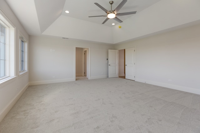 empty room featuring ceiling fan and light colored carpet