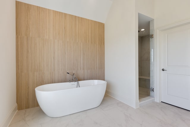 bathroom featuring separate shower and tub and lofted ceiling