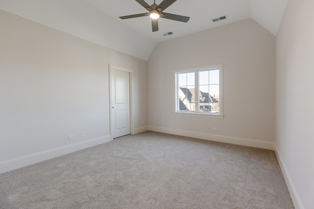 spare room with light carpet, lofted ceiling, and ceiling fan