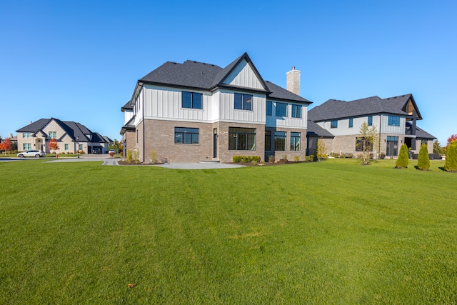 rear view of property with a lawn