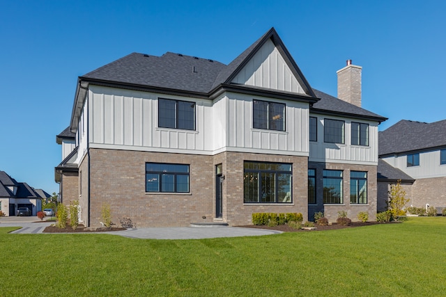 rear view of house featuring a patio and a yard