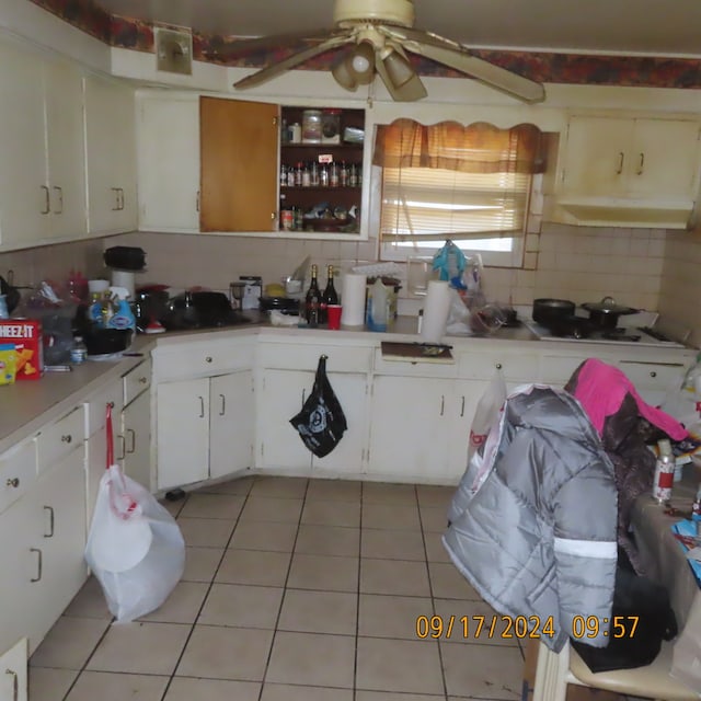 kitchen featuring white cabinetry, backsplash, light tile patterned floors, and ceiling fan