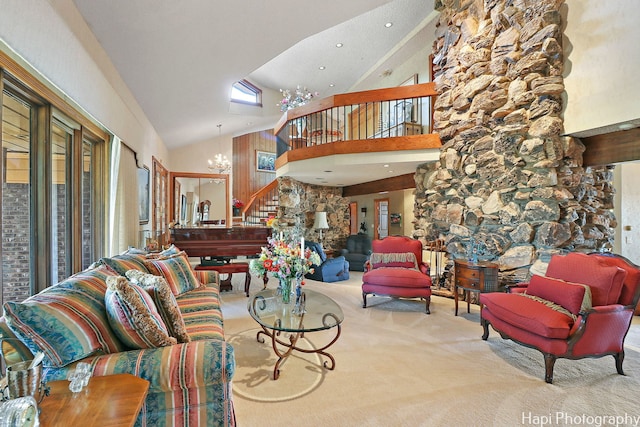 carpeted living room featuring a notable chandelier and high vaulted ceiling