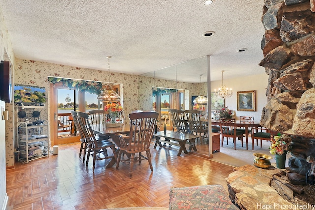 dining room with an inviting chandelier, parquet floors, and a textured ceiling