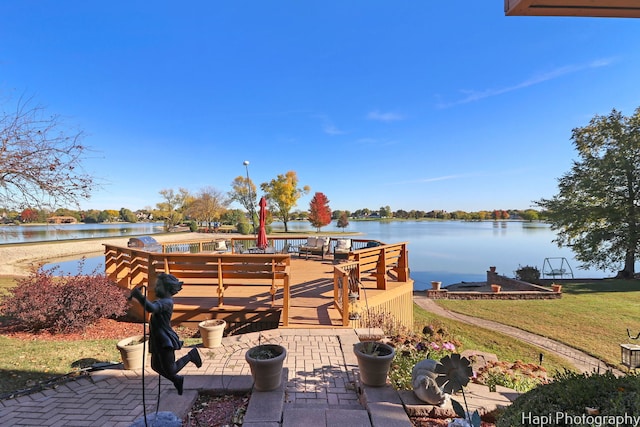 dock area featuring a water view and a lawn