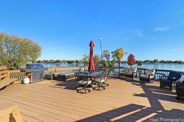 wooden deck featuring a water view and grilling area