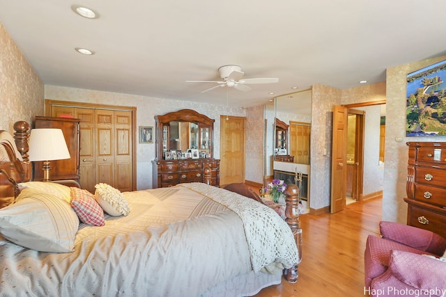 bedroom with light hardwood / wood-style flooring and ceiling fan