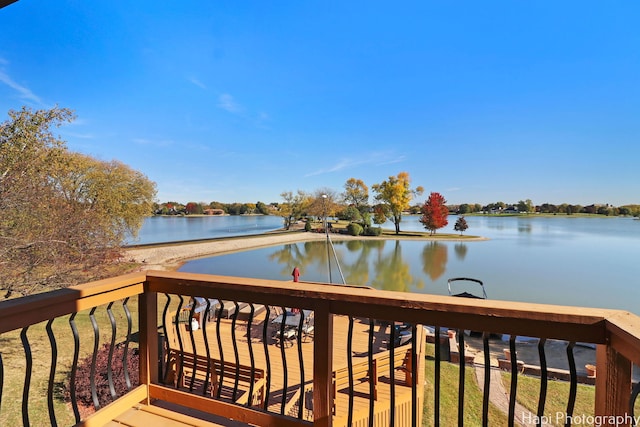 wooden terrace featuring a water view