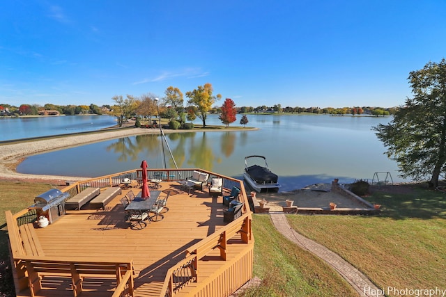 view of dock with a deck with water view and a lawn