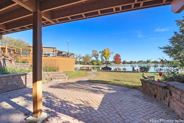 view of patio featuring a deck with water view