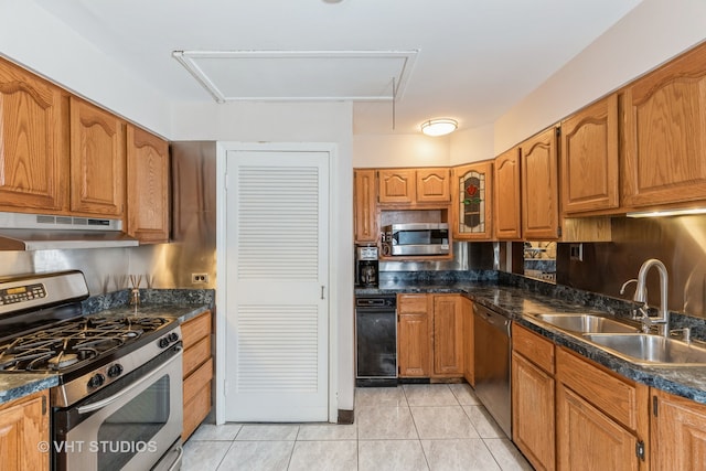 kitchen featuring light tile patterned floors, stainless steel appliances, and sink