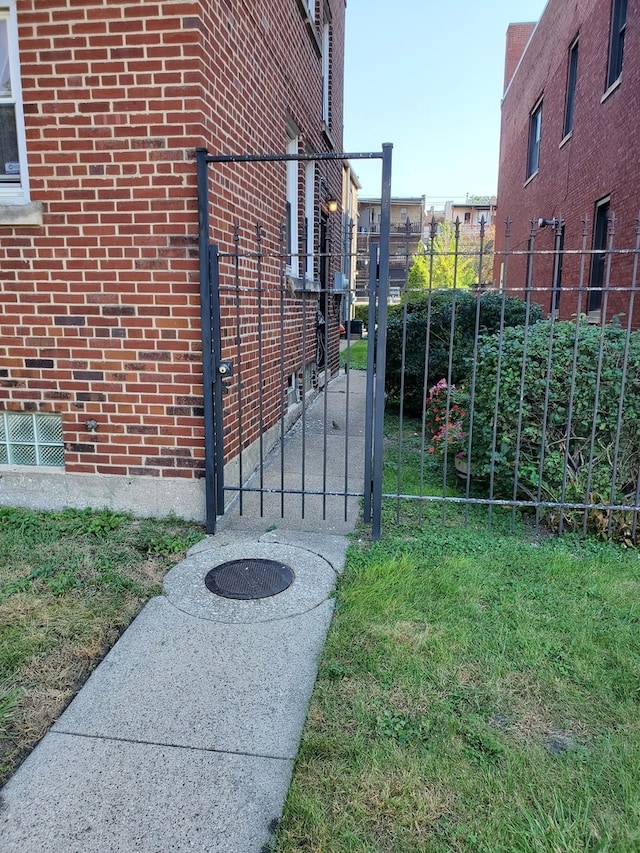 view of gate featuring a lawn