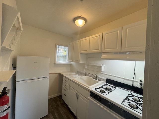 kitchen with dark hardwood / wood-style flooring, white cabinetry, white appliances, and sink