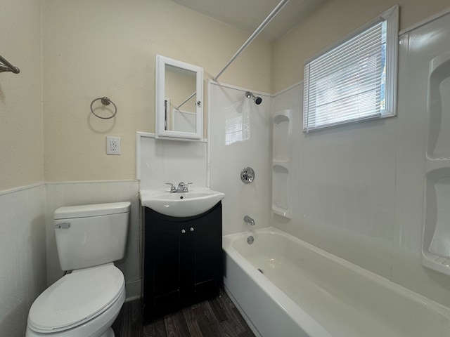 full bathroom with hardwood / wood-style flooring, shower / tub combination, vanity, and toilet